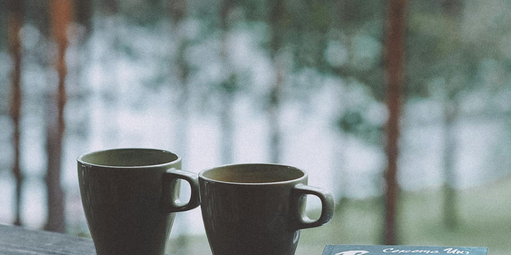 Two coffee mugs on a porch, symbolizing a peaceful retirement and time to enjoy life's simple moments.